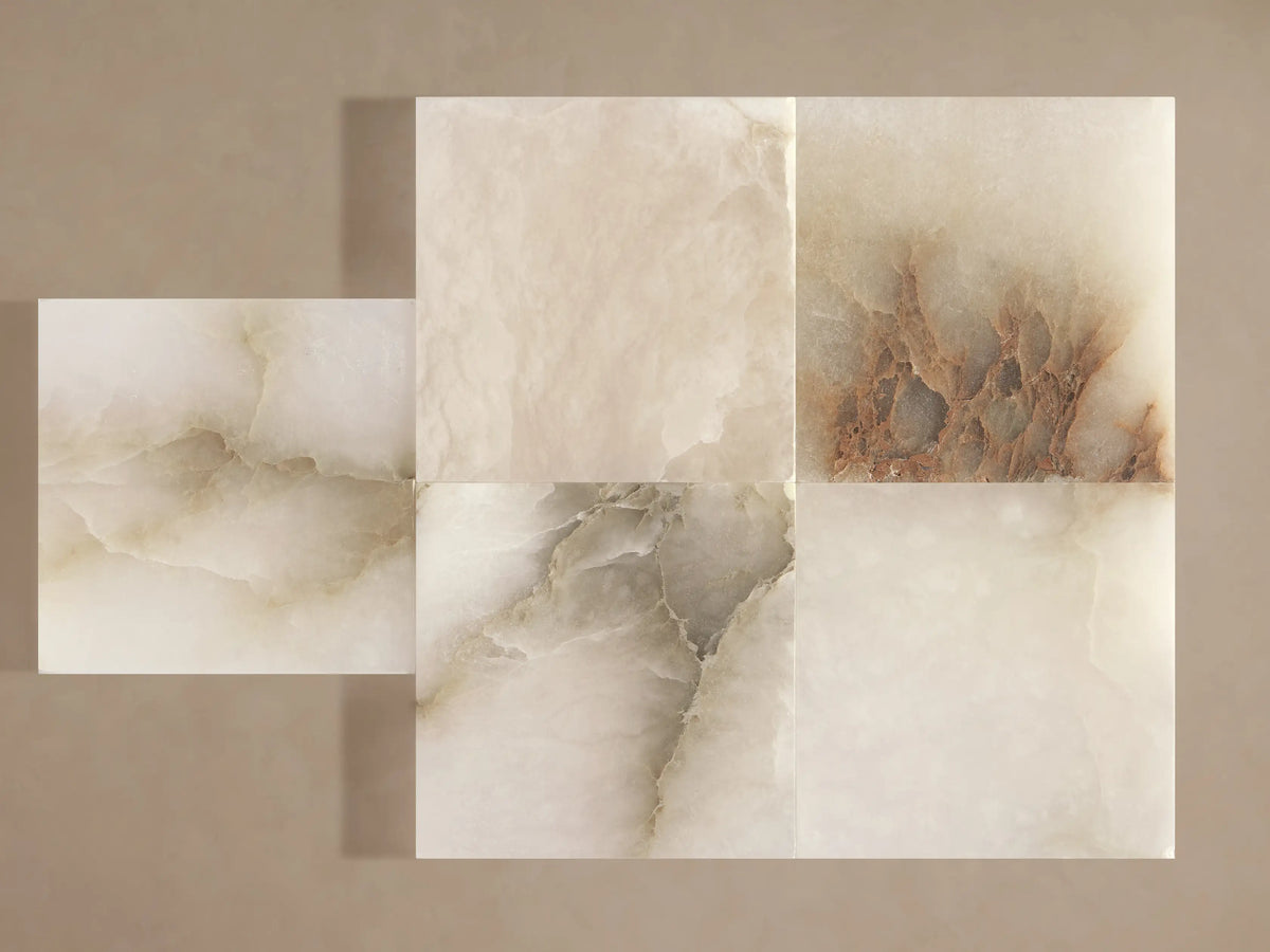Belmira Sconce: Illuminated wall light. Glowing alabaster bowl shade with natural dark veining, mounted on a rectangular brass base.