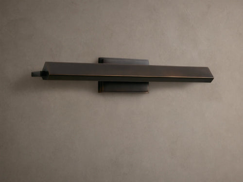 Zaeden Picture Light: Bronze-plated iron horizontal bar light mounted on a neutral wall, highlighting its metallic finish.