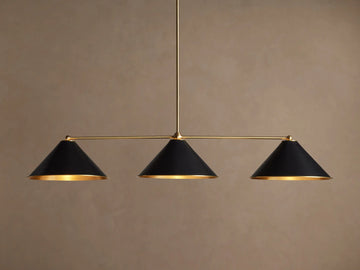 Arno Linear Chandelier with three matte black cone shades and polished brass accents, centered against a neutral wall.