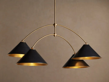 Arno Round Chandelier with a gold brass frame and four matte black conical shades, each with a polished brass interior, hanging.