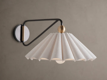 Illuminated Haylen Sconce: black metal arm, circular backplate with antique brass, pleated cream fabric shade.