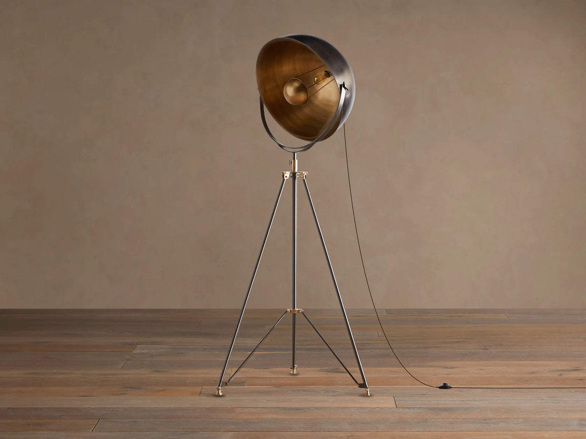 Retro Tripod Floor Lamp with oil-rubbed bronze tripod base & antique brass accents. Round shade has dark exterior, golden interior.