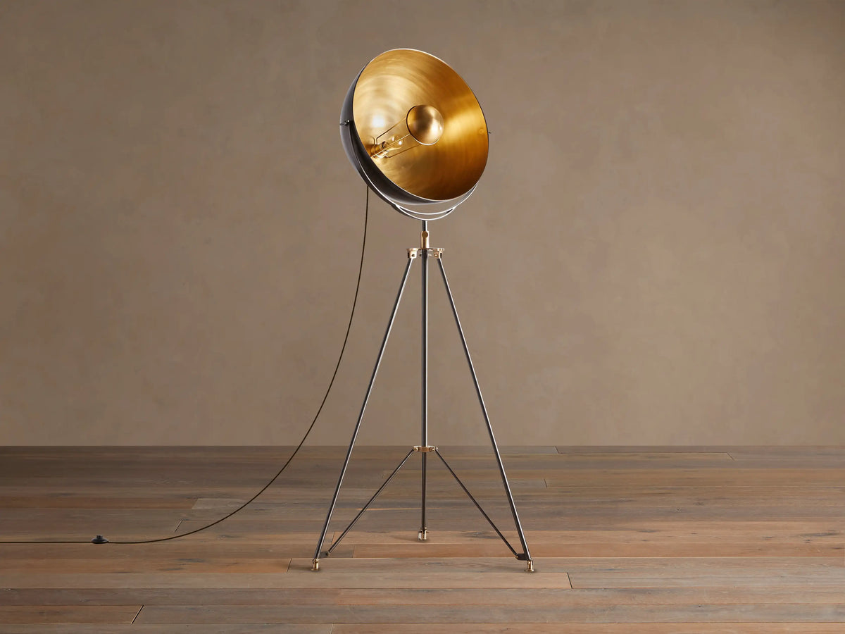 Retro Tripod Floor Lamp with oil-rubbed bronze tripod base & antique brass accents. Round shade has dark exterior, golden interior.