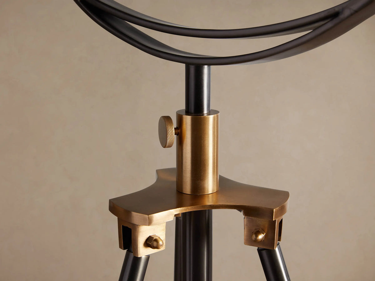 Close-up of Retro Tripod Floor Lamp's warm, shiny brass shade interior and glowing Edison filament bulb.