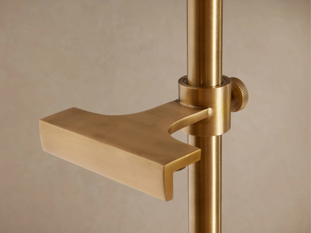 Jaxtyn Easel Floor Lamp. Golden brass, tall floor lamp with adjustable arm, conical shade, and art display supports.