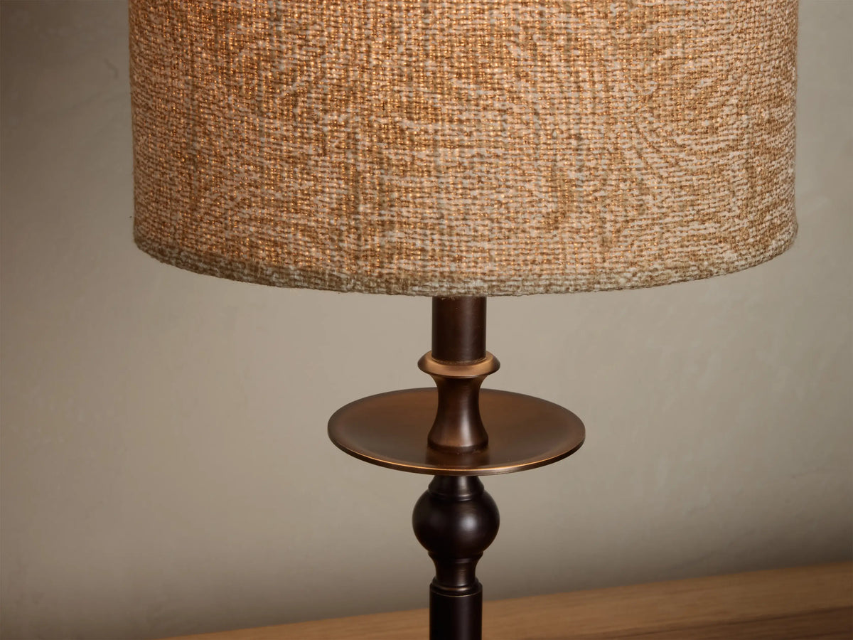 Illuminated Winslow Accent Table Lamp with natural woven fabric shade and dark bronze candlestick base.