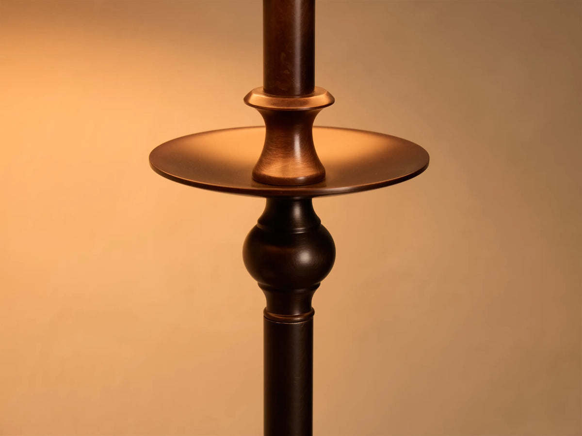Close-up of the antique bronze Winslow Table Lamp, detailing its stem with a flat disc and a decorative spherical section.