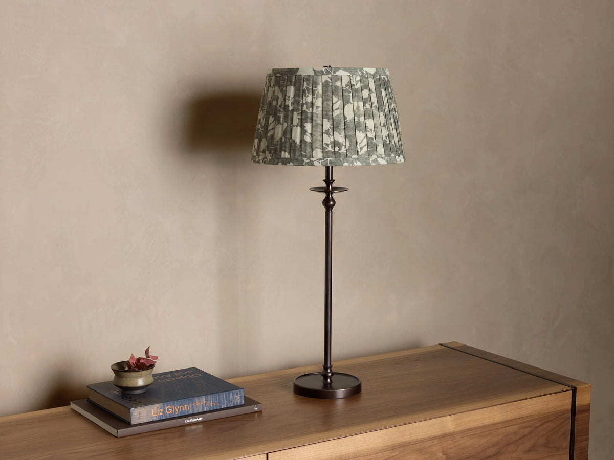 Front view of the Winslow Table Lamp, featuring a dark bronze and antique brass finish, with a pleated patterned fabric shade.