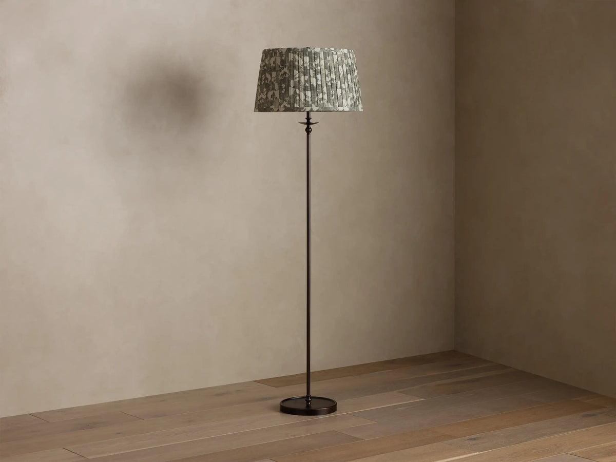 Full view of Winslow Floor Lamp featuring a bronze finish and pleated patterned fabric shade, illuminated.