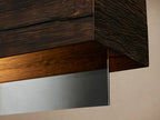 Lena Linear Chandelier: Horizontal dark alder wood bar with a mirrored glass panel, suspended by two black cords.