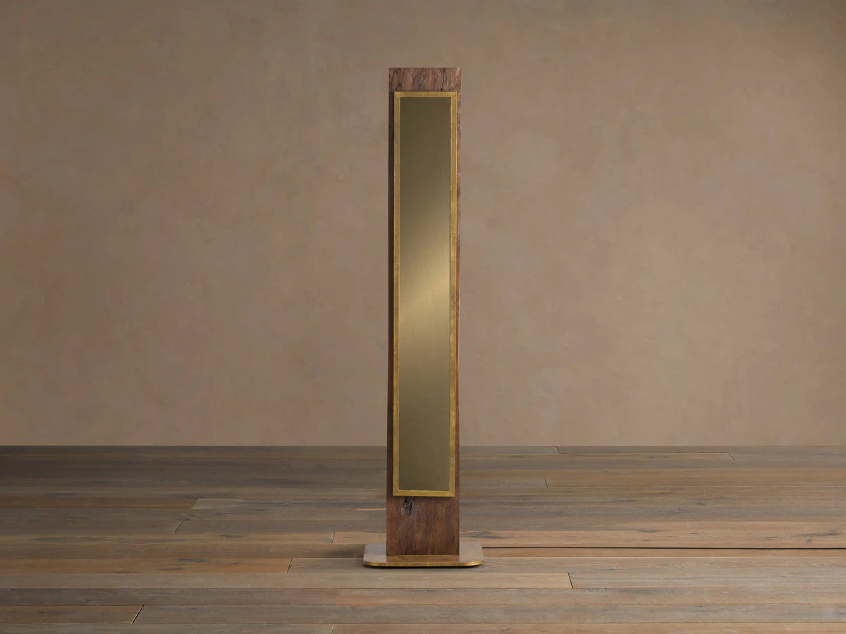 Vigas Floor Lamp: Tall wooden lamp with brass trim, illuminated mirrored glass revealing a textured interior, standing on wood floor.