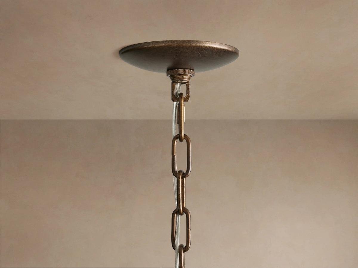 Close-up Paloma Chandelier with tiered, handwoven brown rattan shade, showcasing intricate texture against a light background.