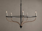 Black iron Rosalind chandelier with five illuminated candle-like bulbs. Curved arms are wrapped in natural rattan.