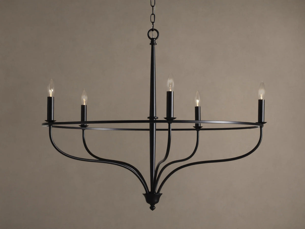 Rosalind Chandelier, matte black, with five lit candelabra bulbs on a circular frame, suspended by a chain.