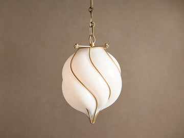 Margolis Small Pendant: White hand-blown glass shade with swirling brass-finished iron bands, hanging from a chain.
