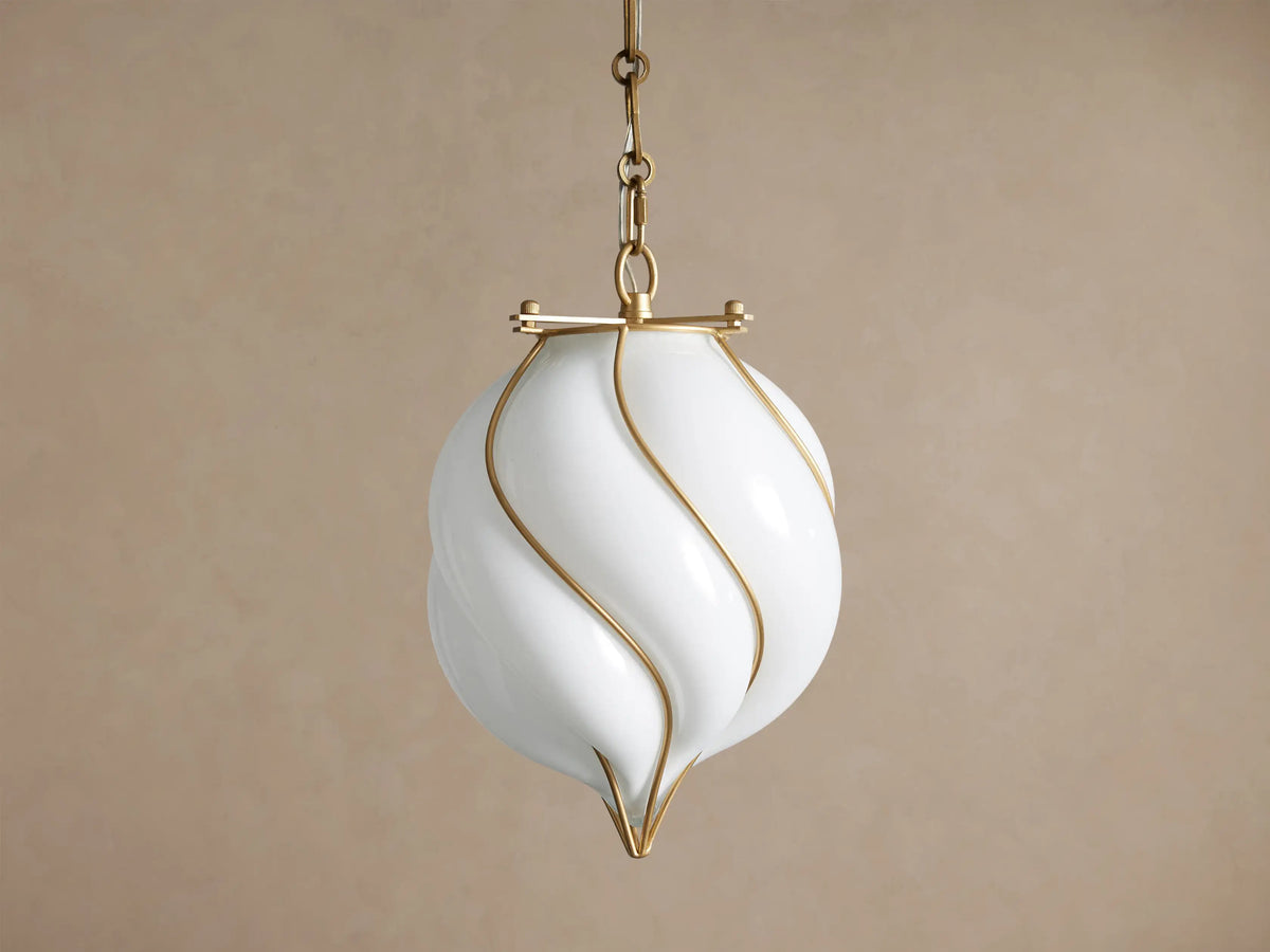 Margolis Small Pendant: White hand-blown glass shade with swirling brass-finished iron bands, hanging from a chain.