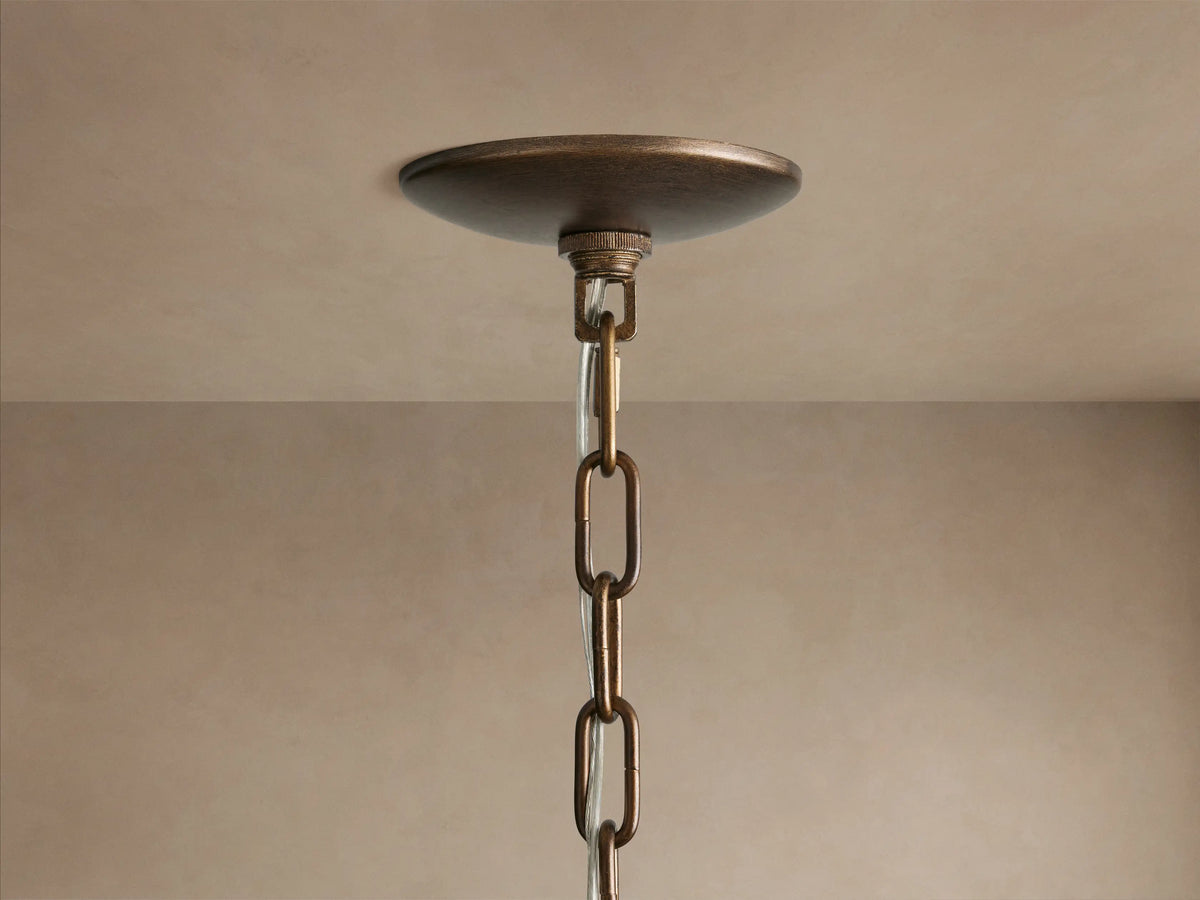 Close-up of Paloma 52" Chandelier: three tiered shades of brown woven rattan, glowing bulbs visible inside.