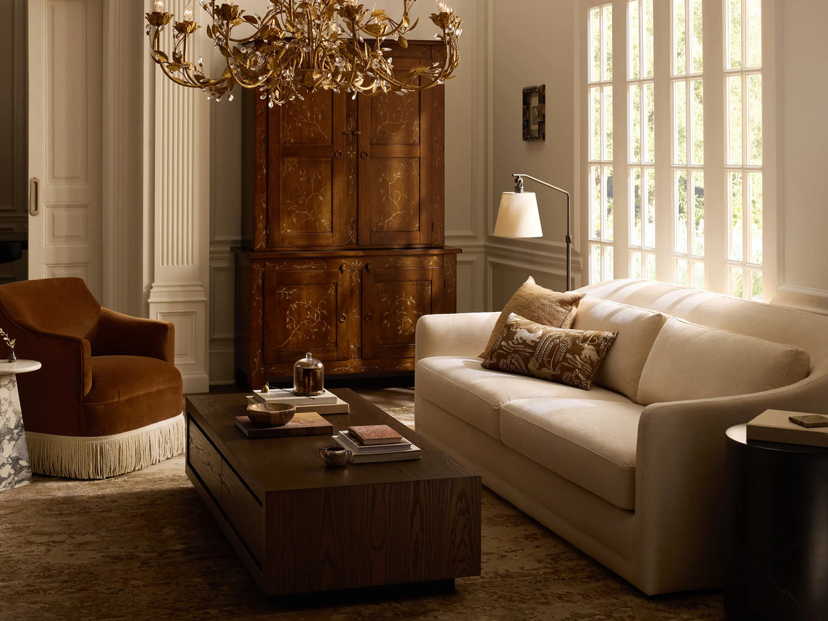 Kellen Floor Lamp: oil-rubbed bronze adjustable stand, angled beige linen shade, lit, on wood floor against plain wall.