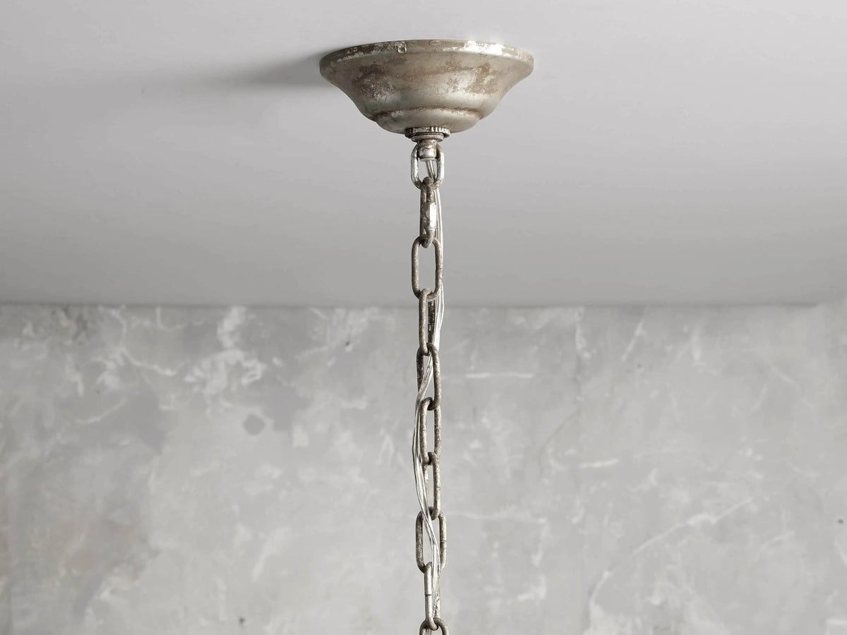 Aubrey Round Chandelier in Silver with cascading glass crystal orbs hanging from a silver iron frame, creating an elegant look.