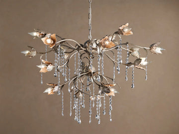 Viticcio Round Chandelier: silver-finished iron branches with warm-toned petal light covers & clear dangling faceted crystals.