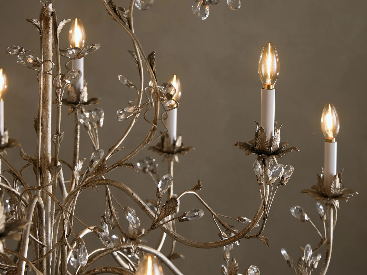 Claudette Chandelier, ornate silver-grey iron with vine-like branches, 12 candle bulbs, and sparkling glass crystals.