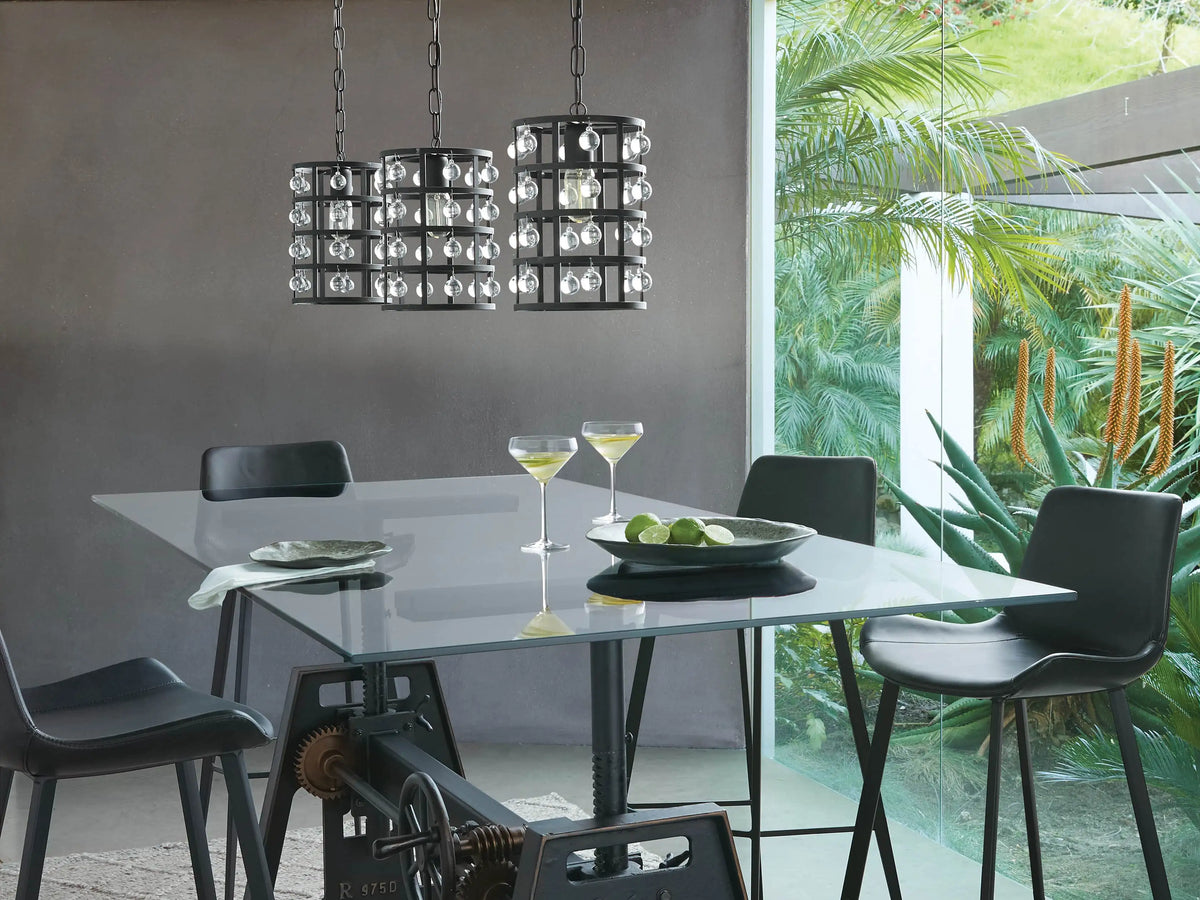 A collection of La Cage Pendant lights in bronze, featuring a metallic iron cage design with crystal spheres, all displayed in various sizes and suspended by chains.