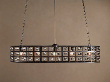 La Cage Oval Chandelier: Dark metal cage frame, oval-shaped, adorned with clear crystal spheres and glowing bulbs, suspended by chains.