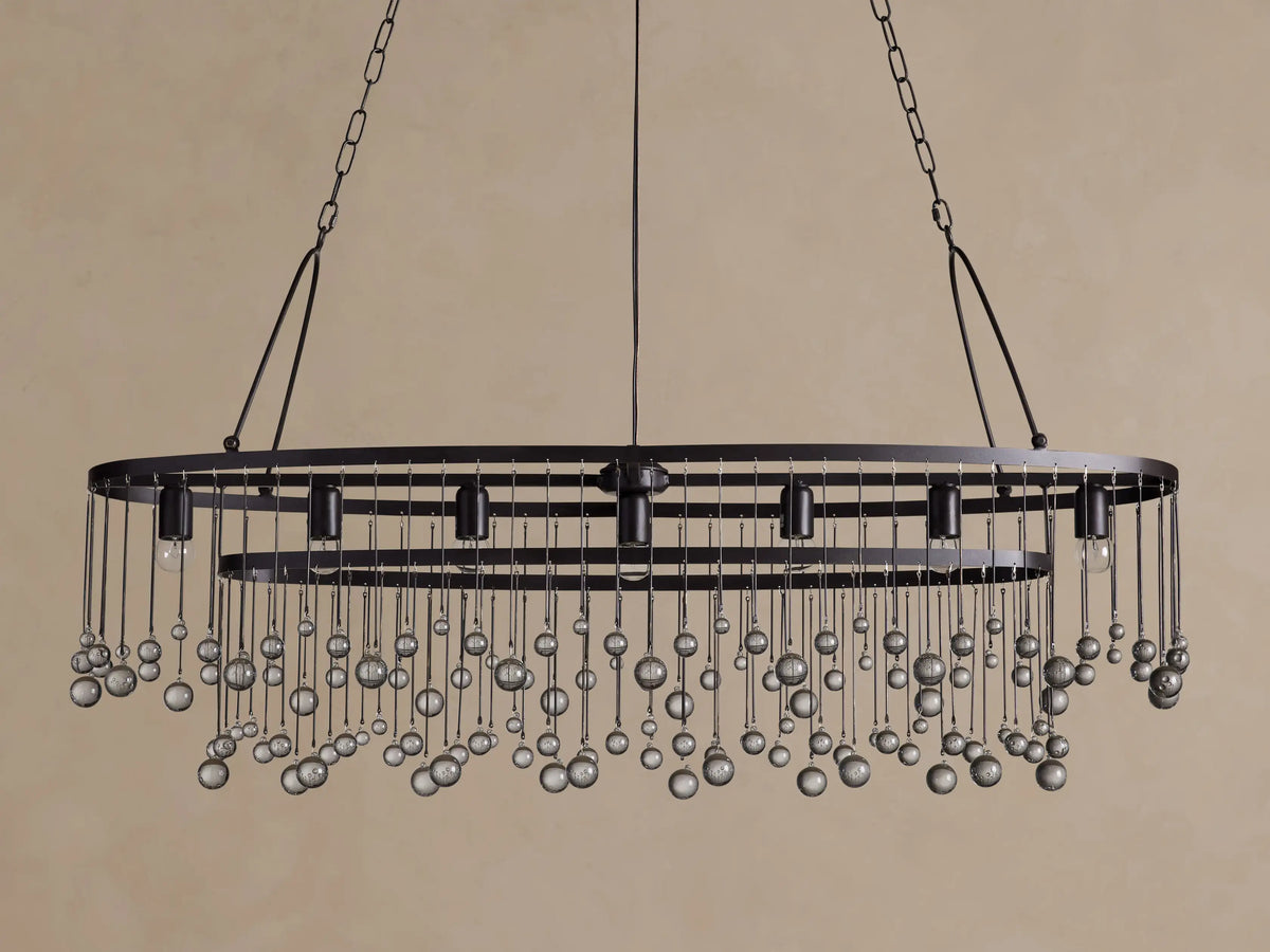 Aubrey Oval Chandelier: Dark iron oval frame with exposed bulbs & numerous hanging clear glass beads.