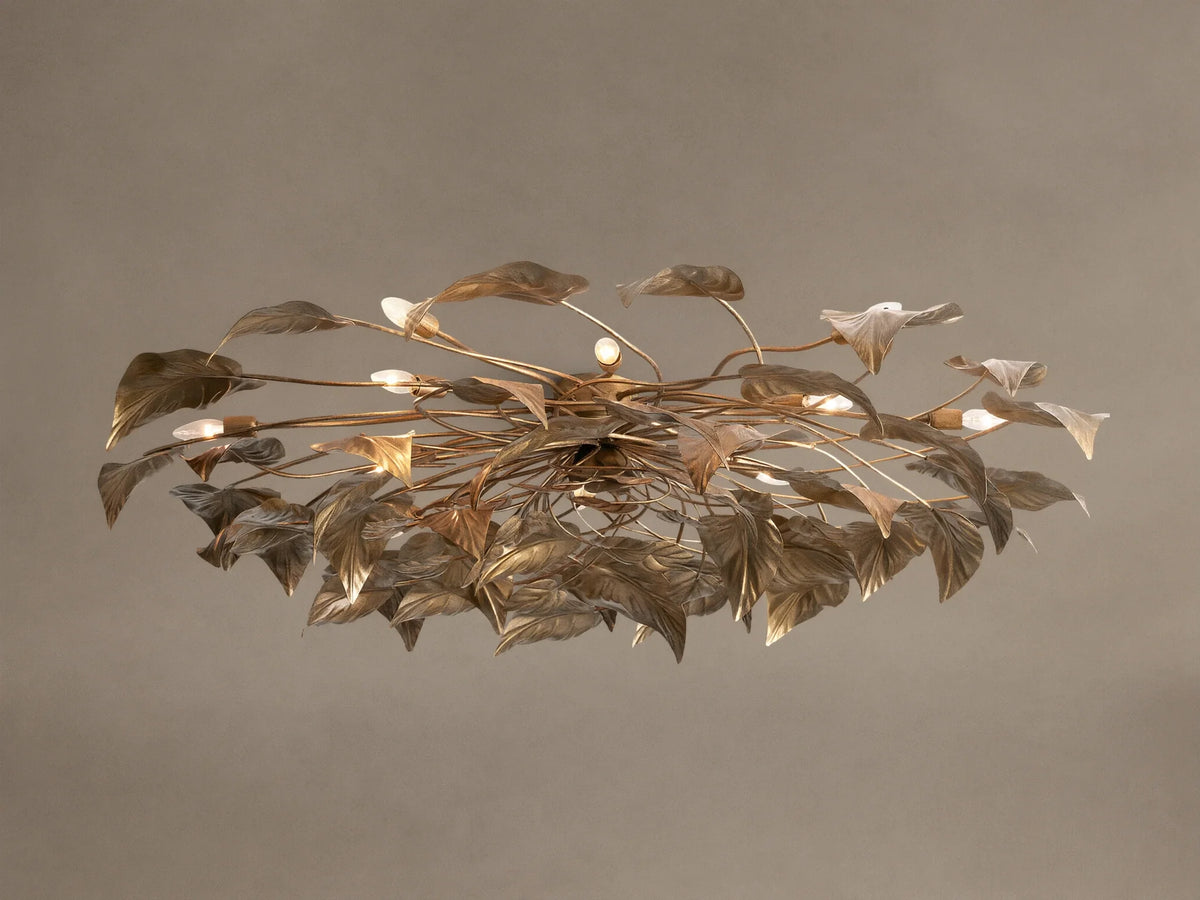 Ornate Ninfea Flush Mount with antiqued gold iron leaves and multiple illuminated candelabra bulbs on a neutral ceiling.