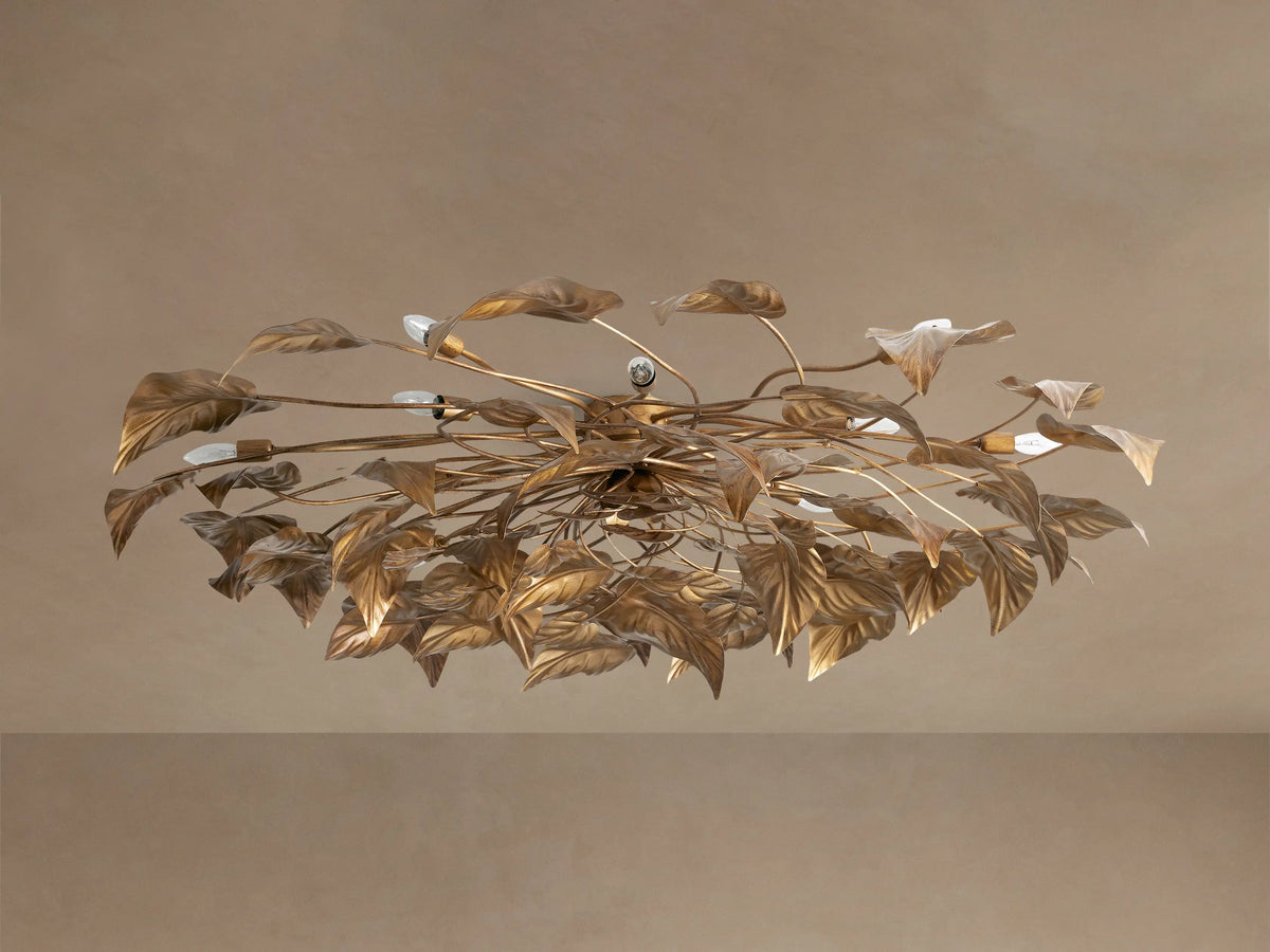 Ornate Ninfea Flush Mount with antiqued gold iron leaves and multiple illuminated candelabra bulbs on a neutral ceiling.