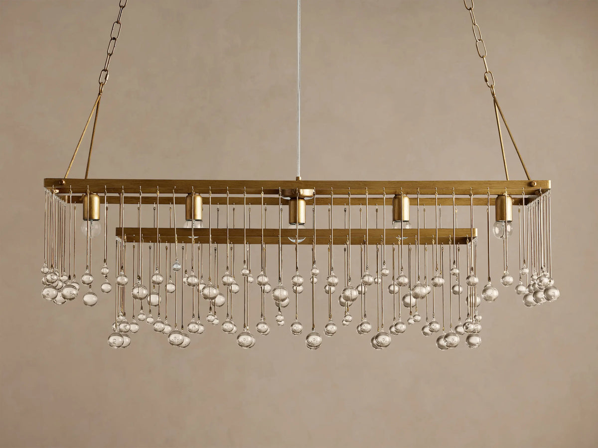 Aubrey Rectangular Chandelier: Gold iron frame, clear glass beads cascading, 4 exposed bulbs, hanging on chains.