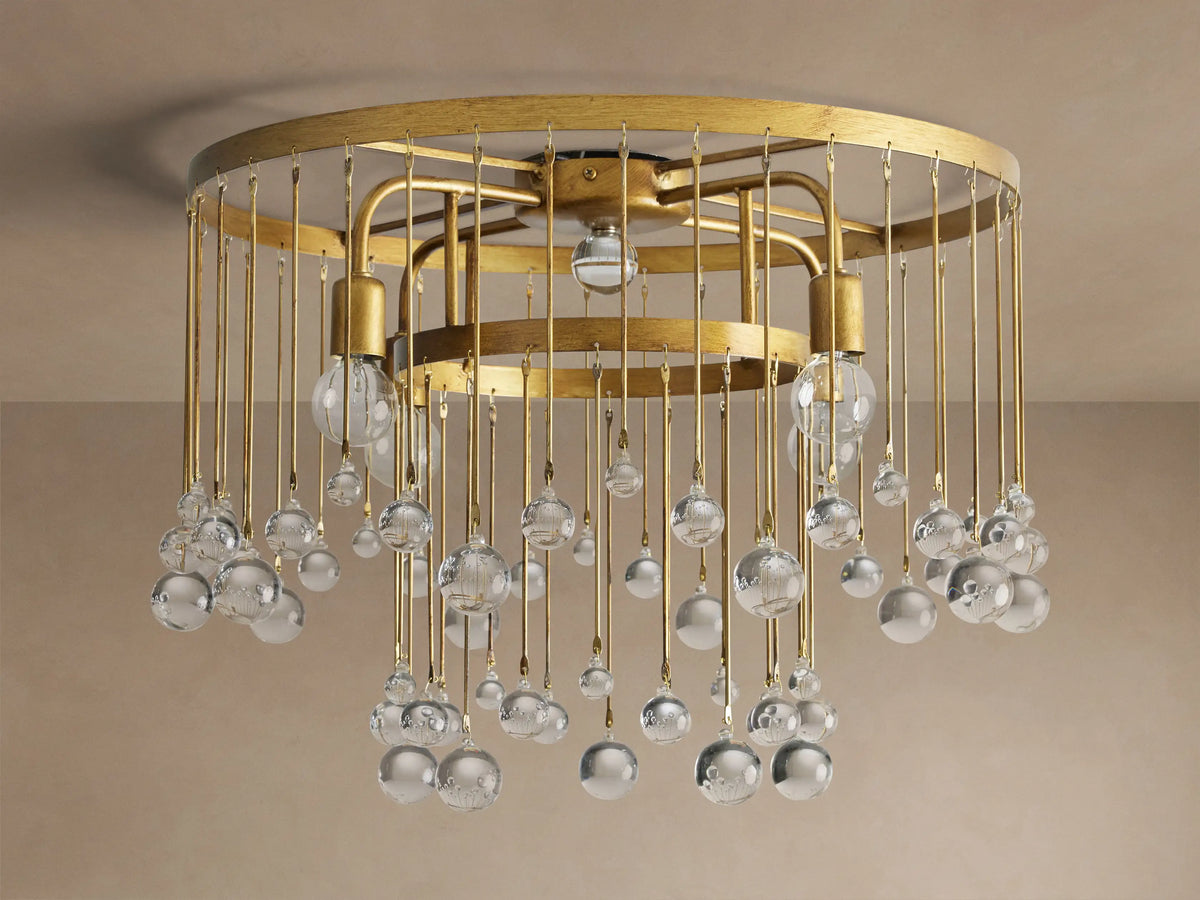 Aubrey Flush Mount light fixture, gold iron frame, dangling clear glass spheres, and visible bulbs, mounted on a ceiling.