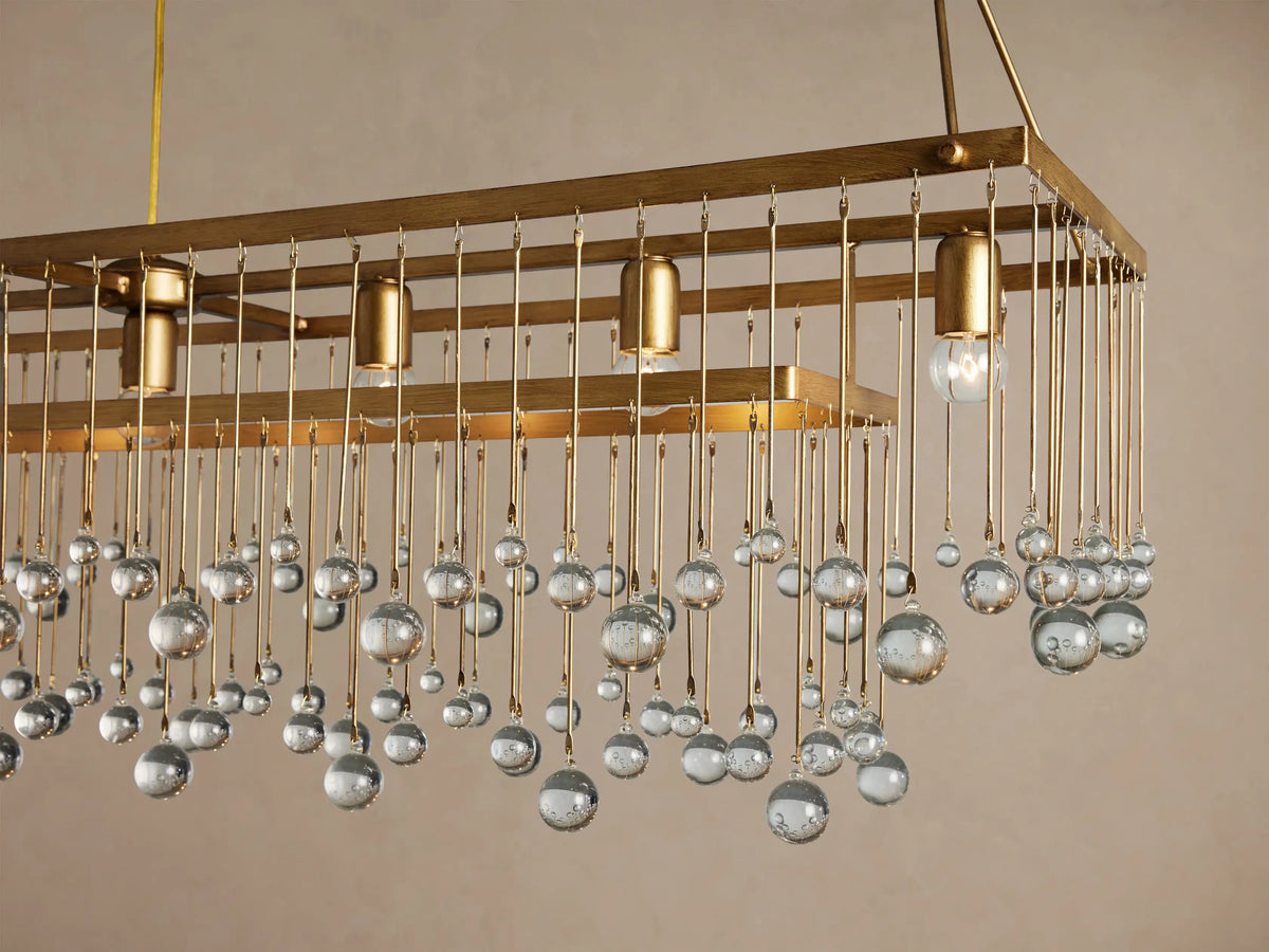 Aubrey Rectangular Chandelier: rectangular gold frame suspended by chains, with multiple lights & clear glass beads cascading down.