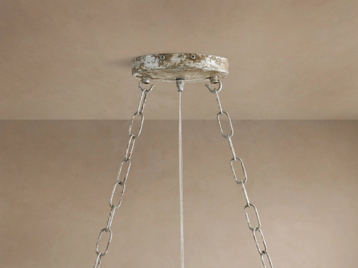 Fiore Linear Chandelier close-up: clear crystal flower with faceted petals and leaves on antiqued silver-finish iron branches.