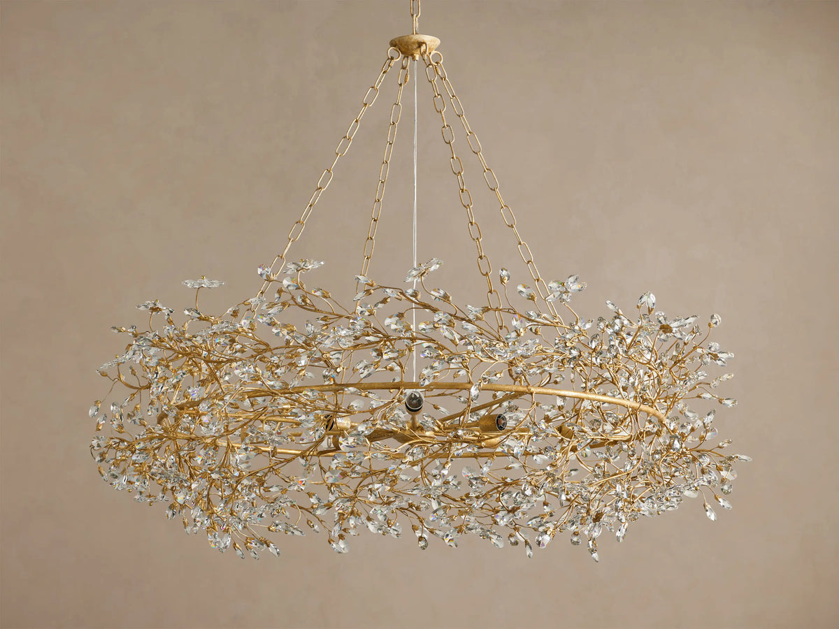 Gold Fiore Crown Chandelier with intricate branch details and clear crystal leaves, suspended by chains against a neutral background.