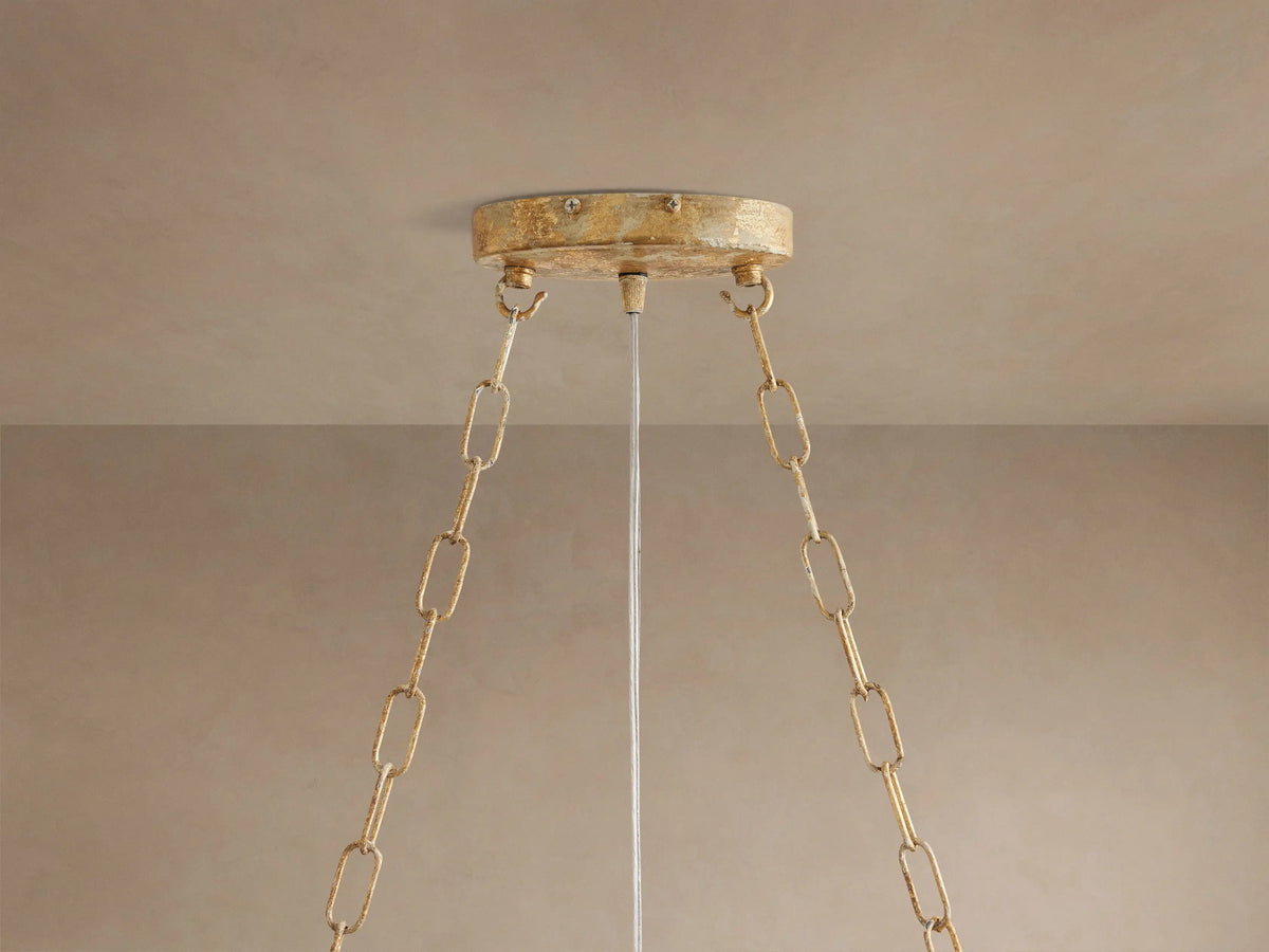 Close-up of Fiore Linear Chandelier with sparkling clear crystal flower petals and buds on delicate gold-finished branches.