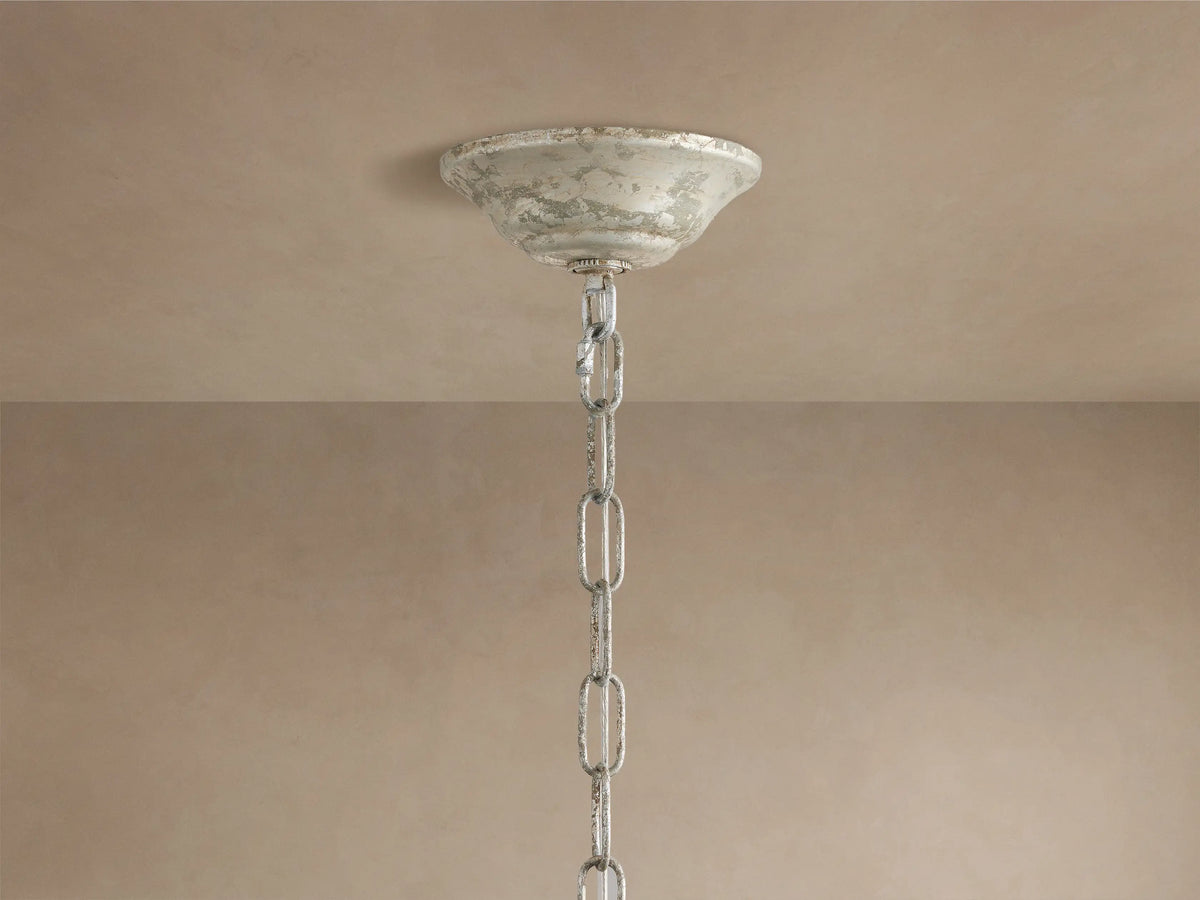 Fiore Crown Chandelier: Antiqued silver ceiling canopy and chain hang from a light beige ceiling.