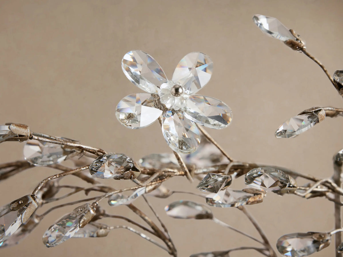 Antiqued silver Fiore Linear Chandelier with branches adorned by numerous clear crystals, hanging from chains.