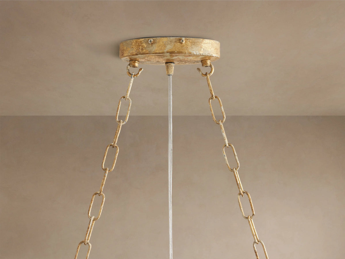 Fiore Linear Chandelier close-up: golden branches with clear faceted crystal flowers and buds, sparkling with light.