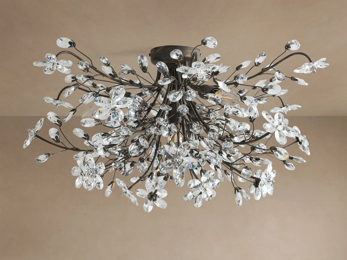 Fiore Flush Mount: Dark bronze ceiling light with branches, adorned with clear, sparkling crystal flowers and leaves, softly glowing.