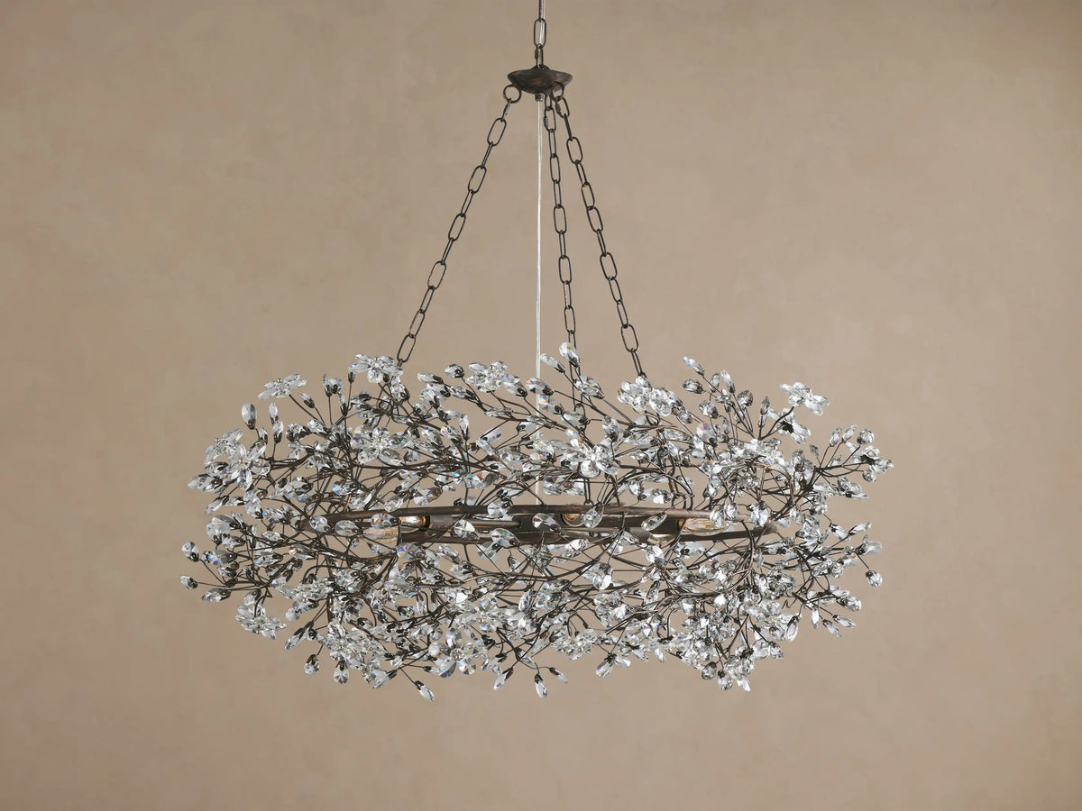 Antique bronze Fiore Crown Chandelier with a circular frame, covered in numerous clear crystal flower-like adornments, hanging.