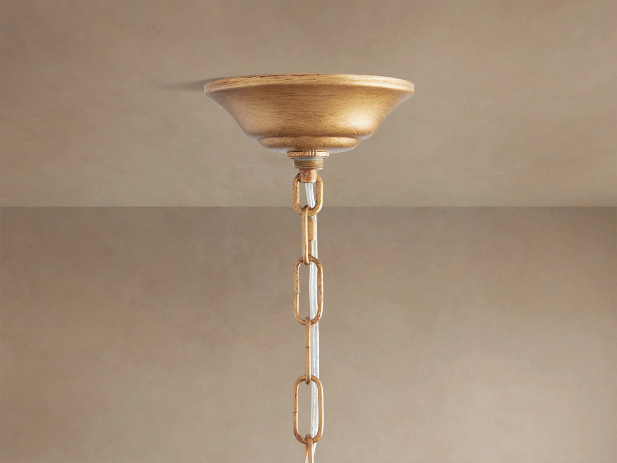 Close-up of Fiore Crown Chandelier with antiqued gold branches and faceted amber/cognac crystal teardrops and flowers.