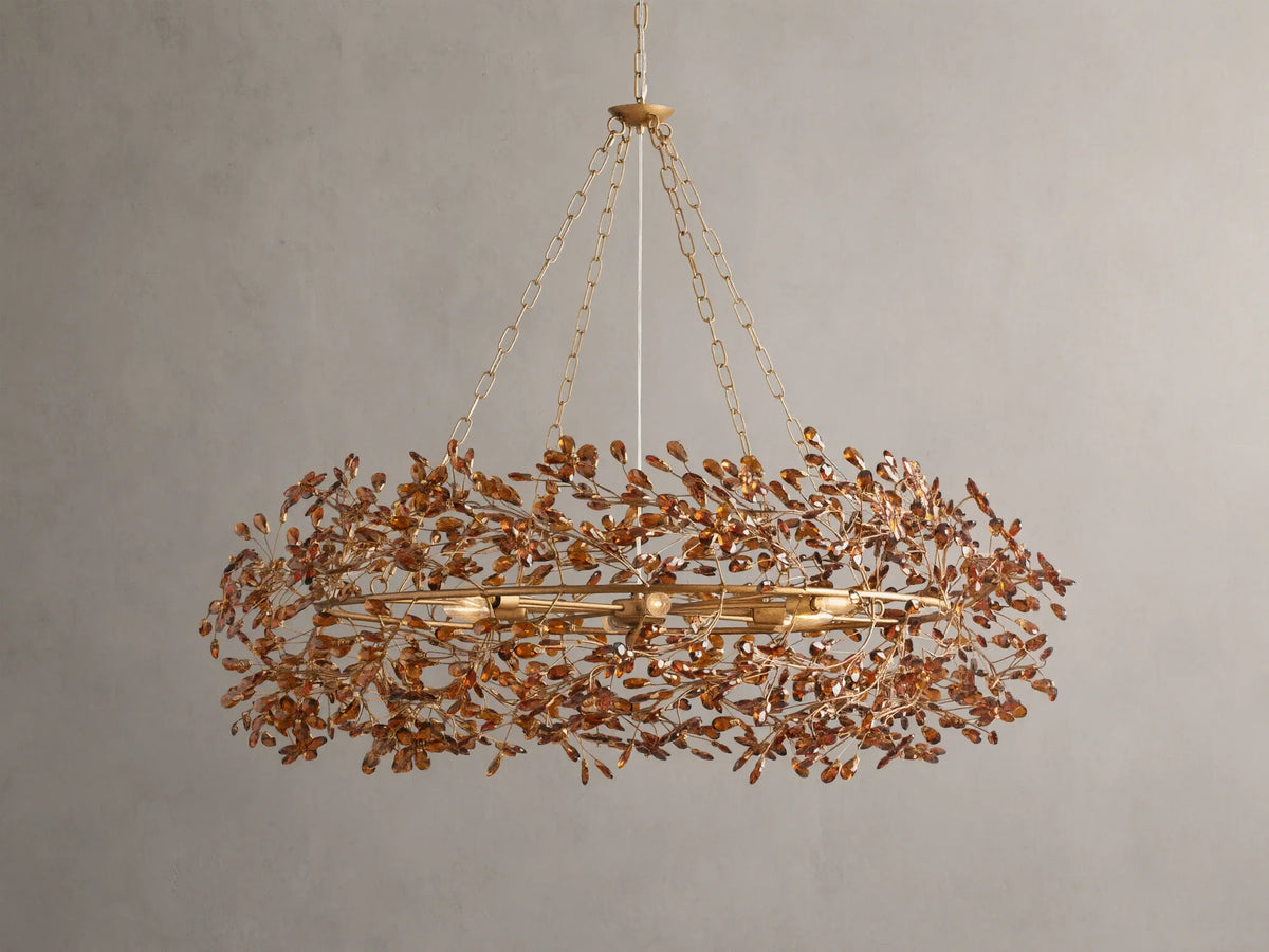 Fiore Crown Chandelier with golden antiqued leaf design, hanging by iron chains, features intricate floral patterns and multiple bulb sockets.