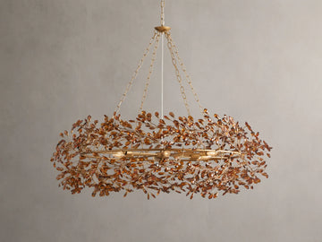 Fiore Crown Chandelier with golden antiqued leaf design, hanging by iron chains, features intricate floral patterns and multiple bulb sockets.