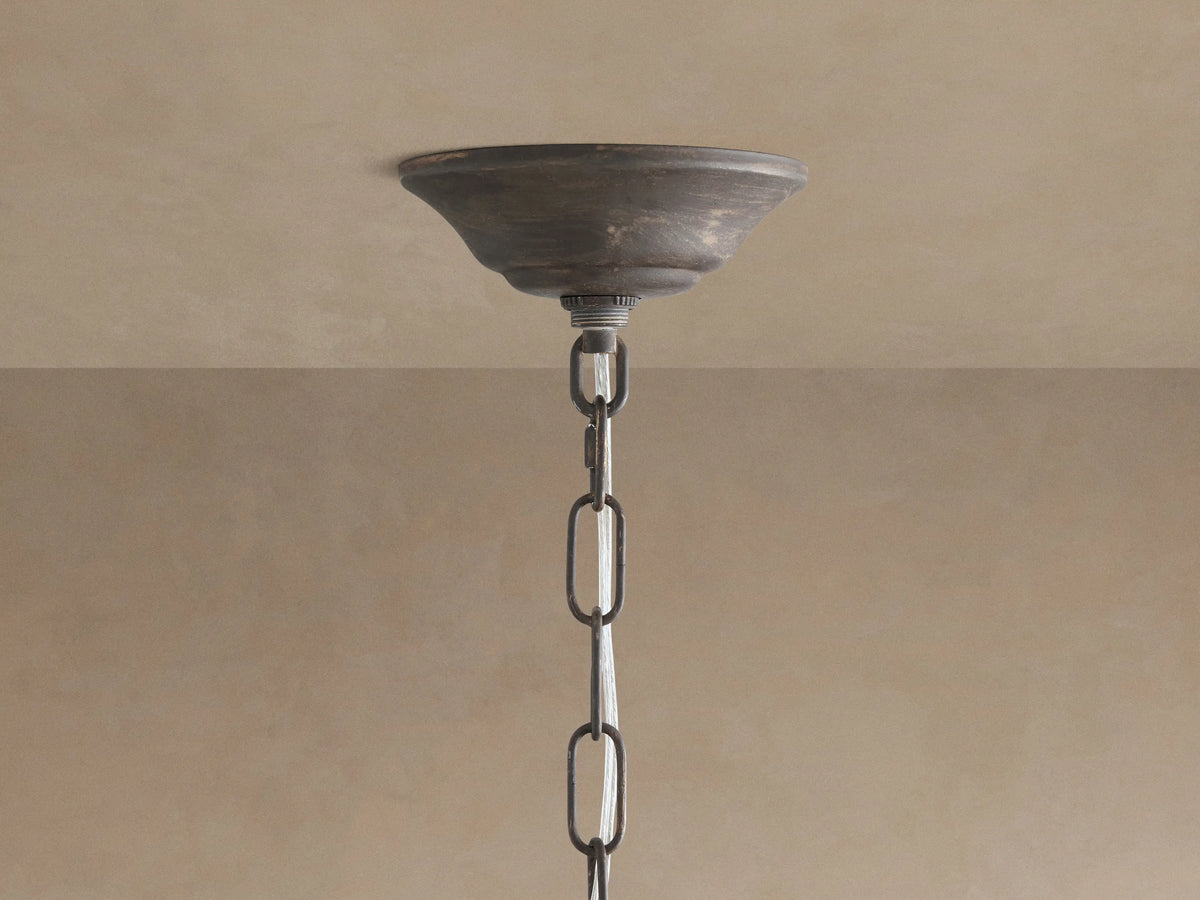 Fiore Crown Chandelier: Dark antiqued metal canopy mounted on a ceiling, with a matching chain and intertwined wires.
