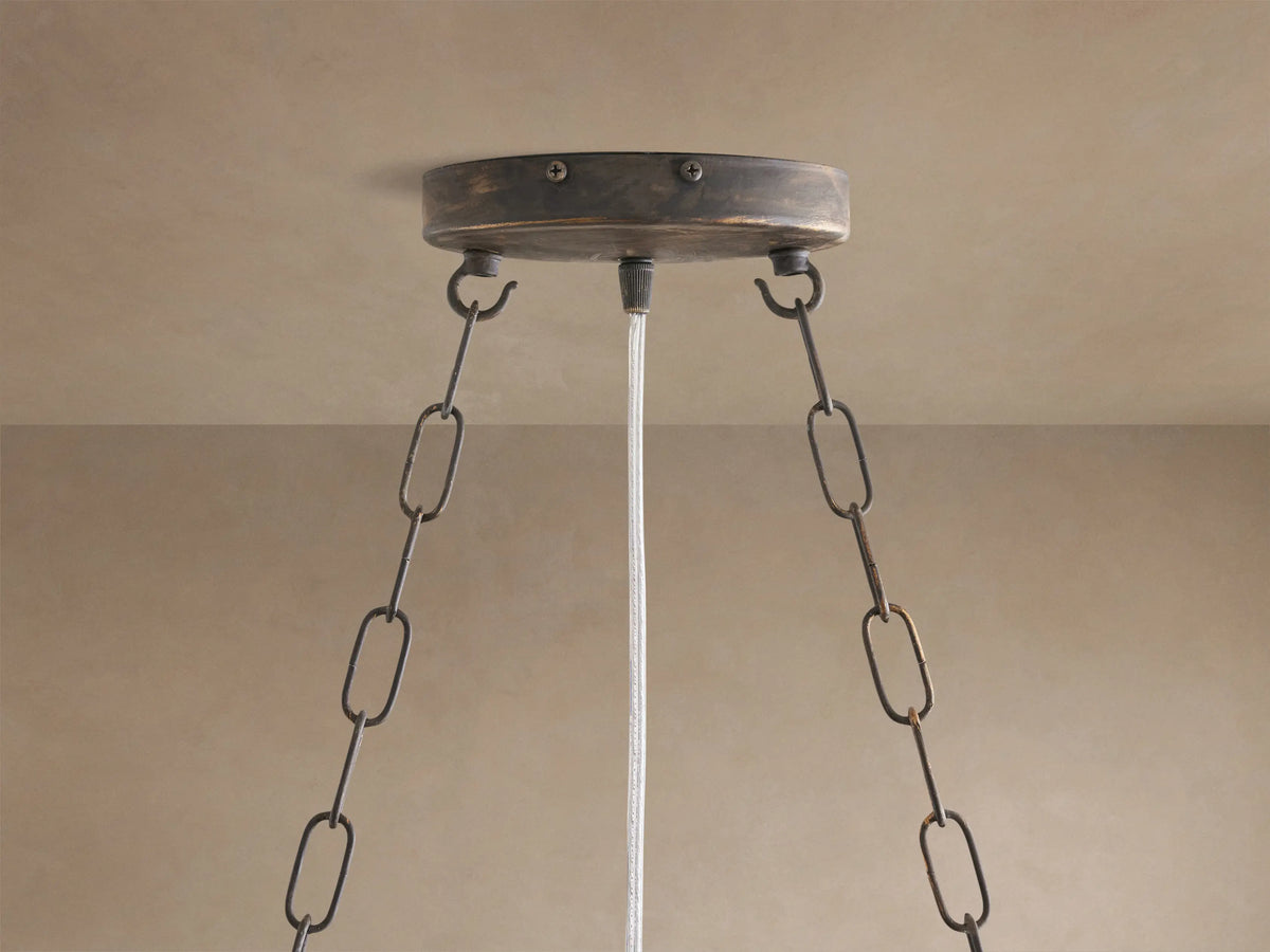 Fiore Crown Chandelier: Distressed bronze ceiling mount with two dark chains & white electrical cord against a light ceiling.