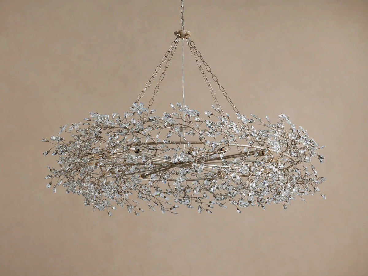 Fiore Crown Chandelier: Ornate oval chandelier in antiqued champagne, densely adorned with shimmering clear crystal leaf clusters.