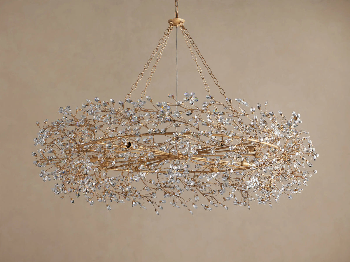 Fiore Crown Chandelier: Oval-shaped golden chandelier with chains, densely covered in sparkling clear crystal leaves.