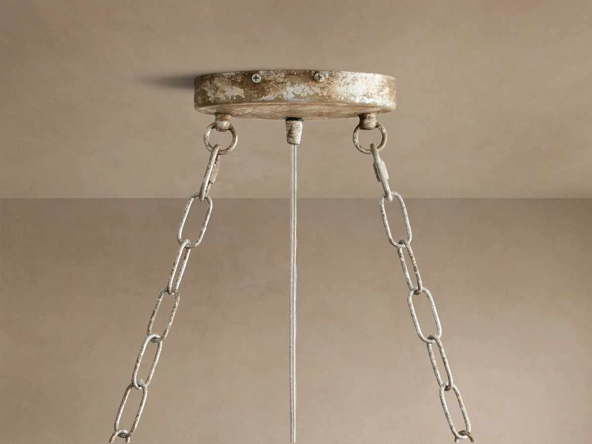 Fiore Oval Chandelier detail: sparkling clear crystal flower with faceted crystal leaves on an antiqued metallic branch.
