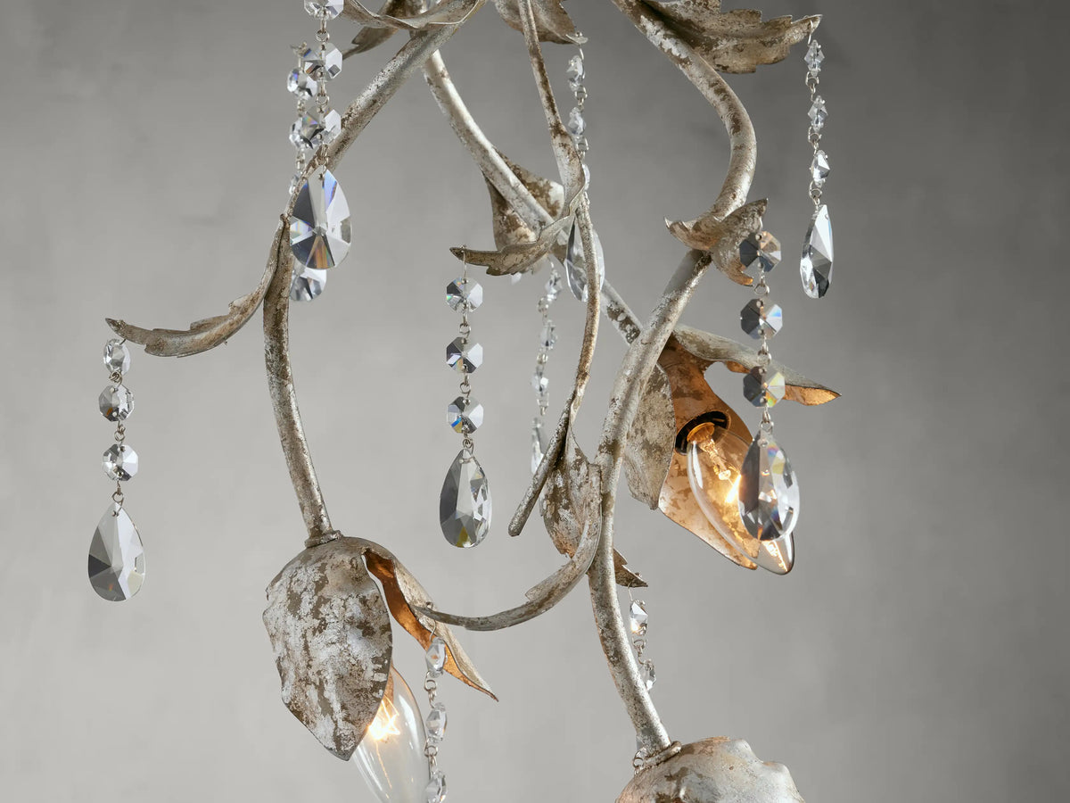 Viticcio Pendant featuring hand-molded silver-finished iron with elegantly strung clear faceted glass crystals, suspended against a gray background.